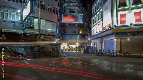 Neon lights on Tsim Sha Tsui street timelapse with traffic.