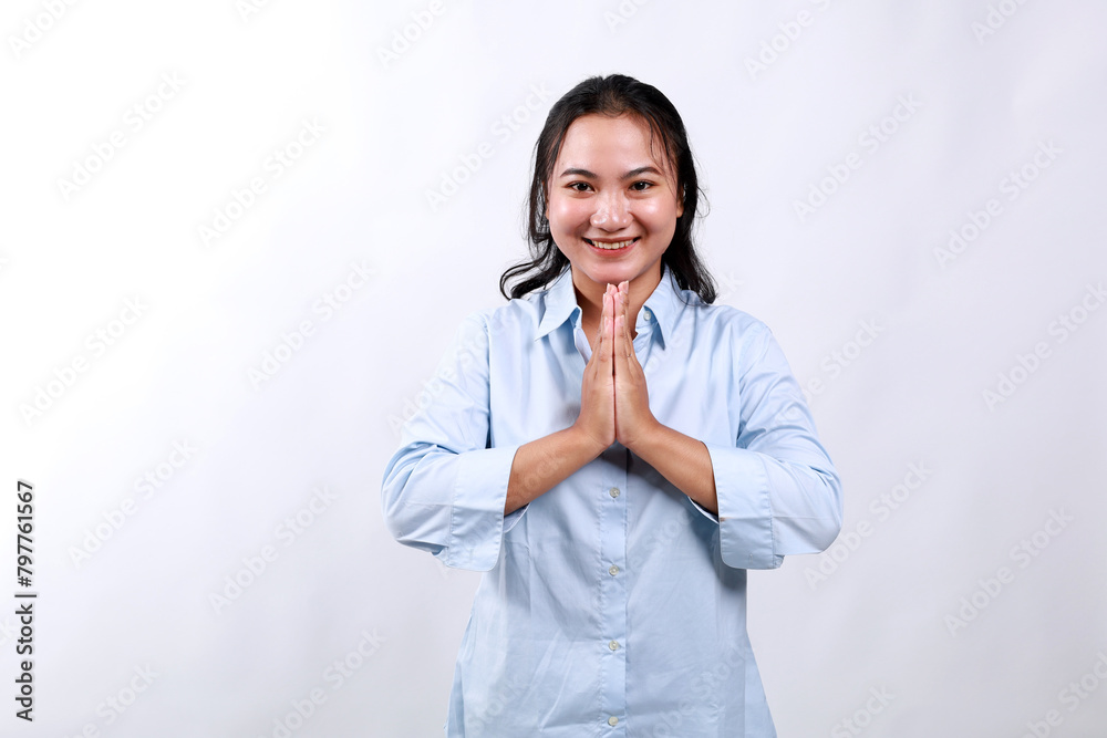 Image of happy asian girl laughing and smiling, showing thank you, namaste gesture, grateful for smth, standing over white background Image of happy asian girl laughing and smiling, showing thank you, namaste gesture, grateful for smth, standing over white background