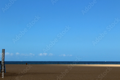 Minimalist beach scene under blue sky