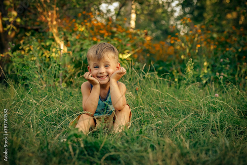 Happy child on the grass in the countryside