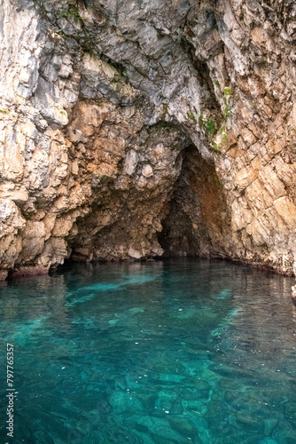 Cliffside view of a cave with turquoise seas in Kotor