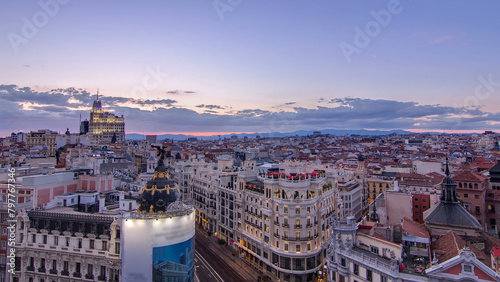 Panoramic aerial view of Gran Via day to night timelapse, Skyline Old Town Cityscape, Metropolis Building, capital of Spain photo