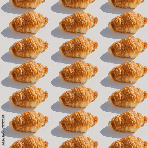 Seamless pattern with freshly baked croissant on white background..