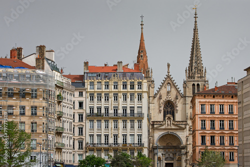 Saint-Nizier church bell towers and facade of buildings of Saone river banks in Lyon