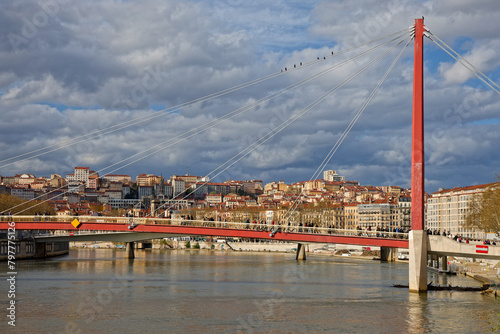 Saone river and pedestrian bridge in lyon, with Croix-Rousse hill in background © Pierre-Jean DURIEU