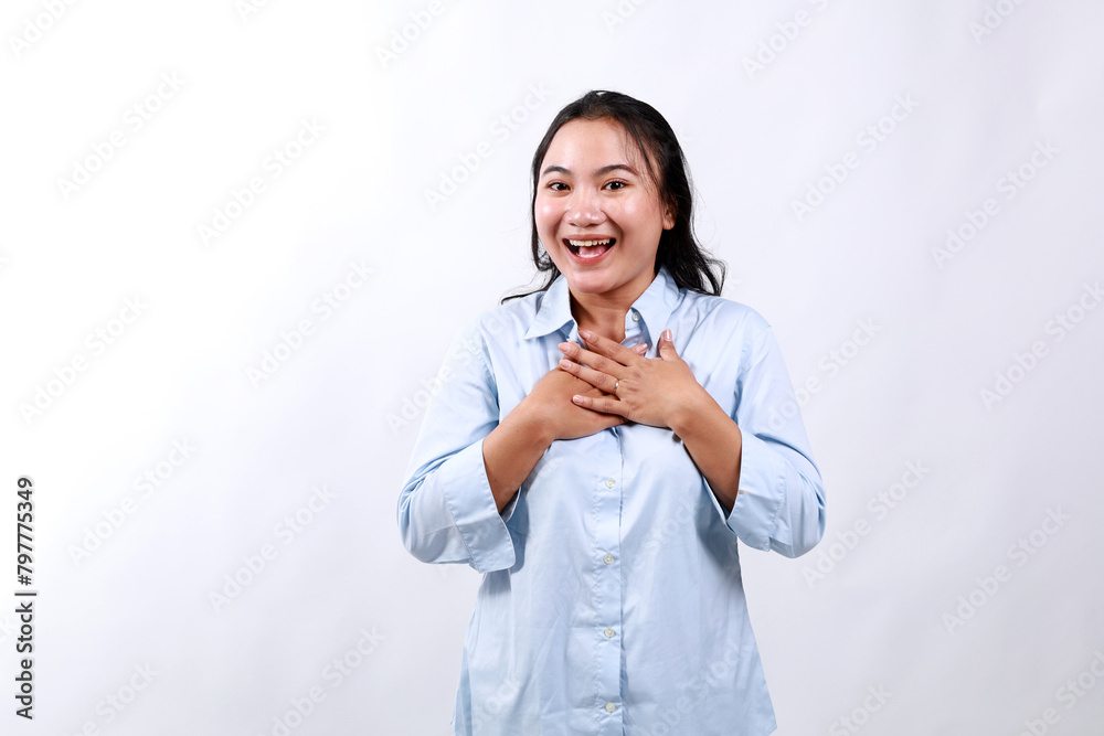 Image of surprised and grateful young woman receive gift, holding hands on chest with flattered smile, saying thank you, being praised, standing over white background. Image of surprised and grateful young woman receive gift, holding hands on chest with flattered smile, saying thank you, being praised, standing over white background.