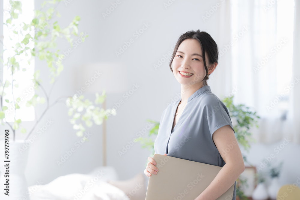 Beautiful woman with laptop in beautiful office window Holding computer and smiling for camera Beautiful woman with laptop in beautiful office window Holding computer and smiling for camera