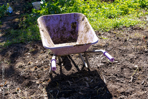 Wallpaper Mural High angle view of wheel barrow at garden of Swiss farm at Swiss City of Zürich on a sunny spring day. Photo taken April 27th, 2024, Zurich, Switzerland. Torontodigital.ca