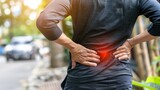 A person suffering from Back Pain. glow on the lower back of bad posture, office syndrome backache, and stress of the body.