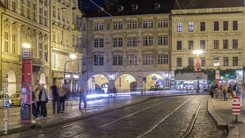 Night view of the illuminated malostranske namesti square timelapse in prague photo