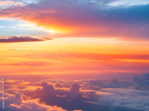 Dramatic amazing sky and clouds from above at sunset. Colorful pastel sky