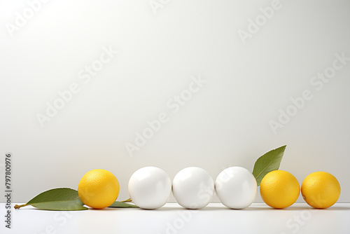 White and yellow easter eggs with green leaves on a white background