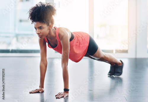 Black woman, push up and exercise in gym for fitness, strong arms and core or abs in workout. Female person, training and body challenge for bodybuilder, resilience and cardio routine for wellness