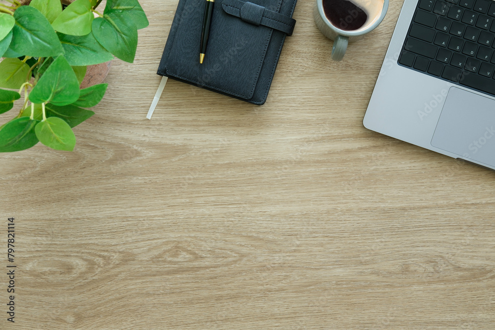 Laptop computer, coffee cup and notebook on wood background. Top view. Laptop computer, coffee cup and notebook on wood background. Top view.