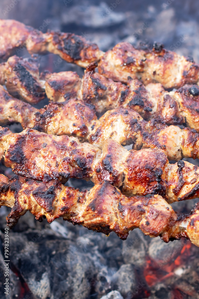 Food being grilled on skewers, creating a delicious Souvla recipe over charcoal Food being grilled on skewers, creating a delicious Souvla recipe over charcoal