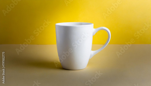 Close-up of ceramic white cup on isolated yellow background. Tea or coffee mug. Drink ware. Mock up.