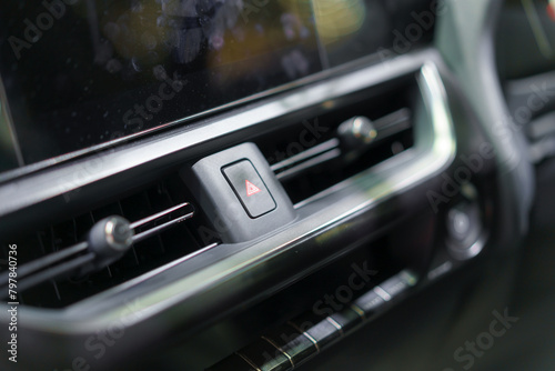 Close-up red emergency hazard light switch button in interior of modern car