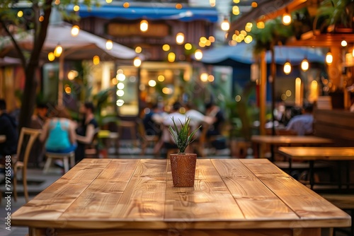 A charming outdoor caf   scene with a wooden table and a potted plant  illuminated by festive string lights