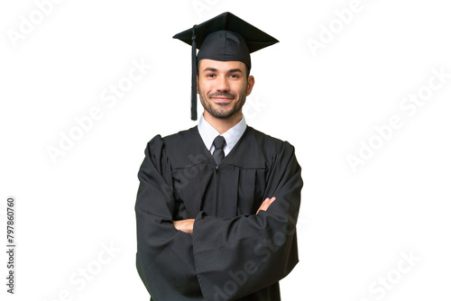 Young university graduate man over isolated background keeping the arms crossed in frontal position