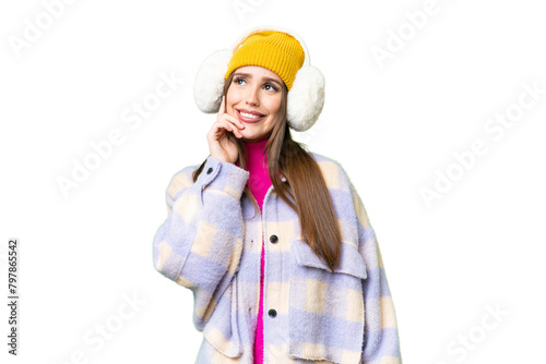 Young woman wearing winter muffs over isolated chroma key background thinking an idea while looking up photo