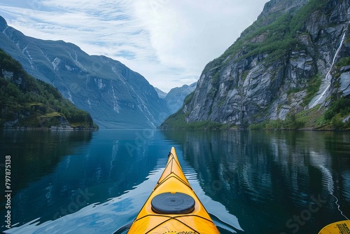 A stunning kayak expedition in the tranquil blue waters of Norway's mountainous fjords, with crystal clear skies © Pinklife