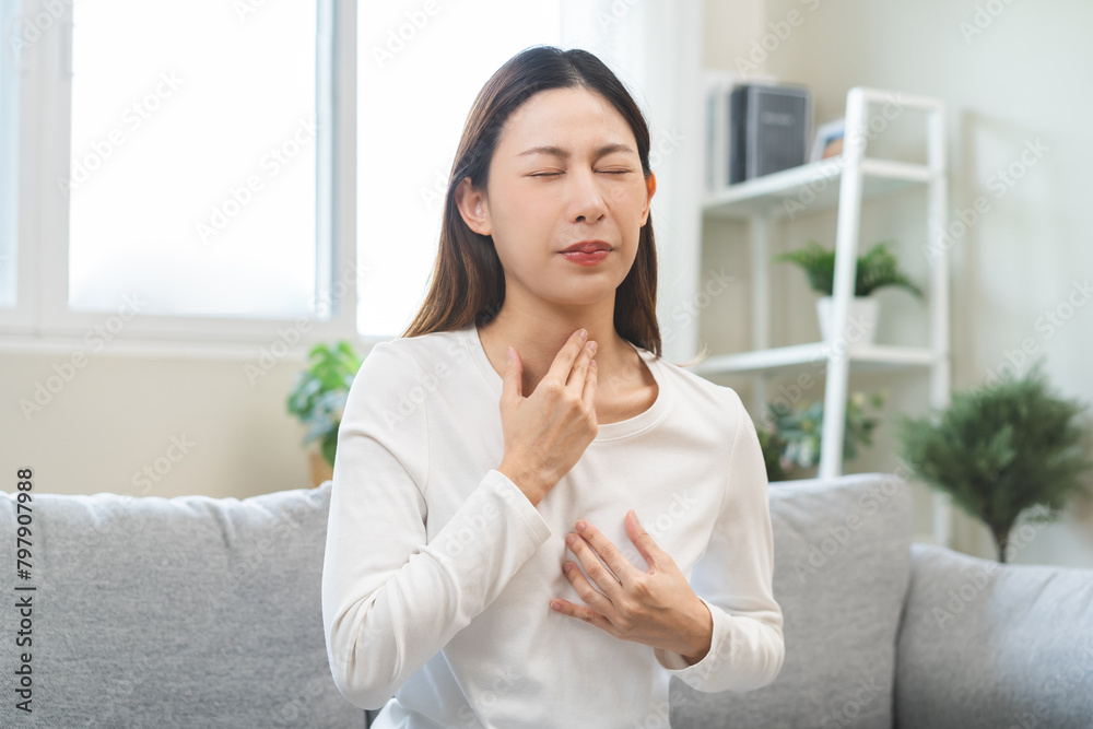 Acid reflux disease, suffer asian young woman have symptom gastroesophageal, esophageal, stomach ache and heartburn pain hand on chest from digestion problem after eat food, Healthcare medical concept Acid reflux disease, suffer asian young woman have symptom gastroesophageal, esophageal, stomach ache and heartburn pain hand on chest from digestion problem after eat food, Healthcare medical concept