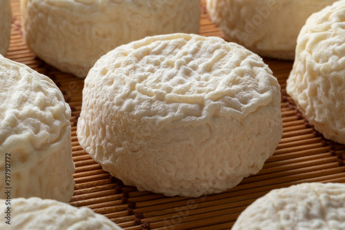 Group of fresh made French Crottin de chevre on wicker surface close up  © Picture Partners