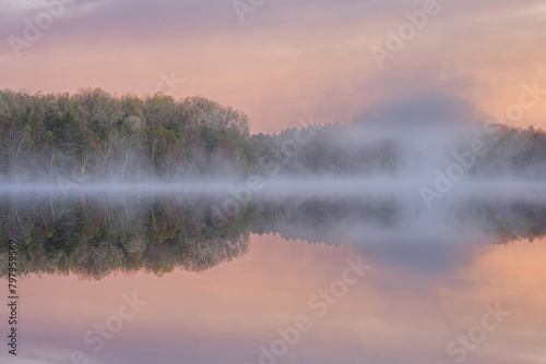 Foggy spring landscape at dawn of Moccasin Lake with mirrored reflections in calm water, Hiawatha National Forest, Michigan's Upper Peninsula, USA photo