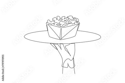 Single continuous line drawing the waiter holds a food tray serving popcorn. Made from popcorn. Avoid aging. Friends when watching movie. Has a salty taste. Snacks One line design vector illustration