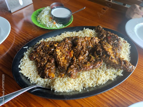 rice with chicken. chicken with rice and vegetables. Arabic food kuzhi mandhi  photo