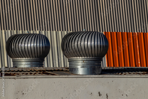 Ventilation heater on roof in brazilia factory. Rotary chimney aspirator on the industrial roof in Brazil photo