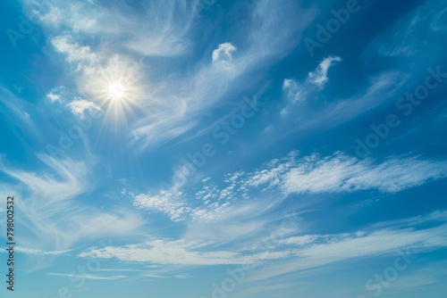 b'Blue sky with white clouds and bright sun' photo