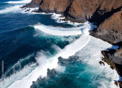 Drone view of Tenerife south coast with Atlantic ocean and strong swell beating against the walls of a rocky cliff