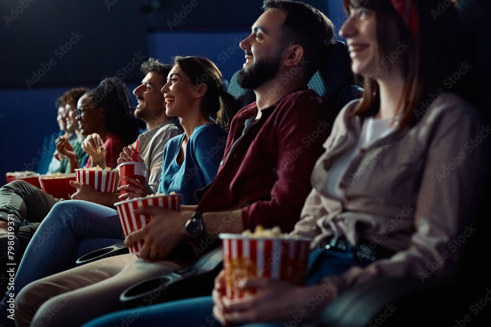 Obraz premium Happy woman watching movie with friends in cinema.