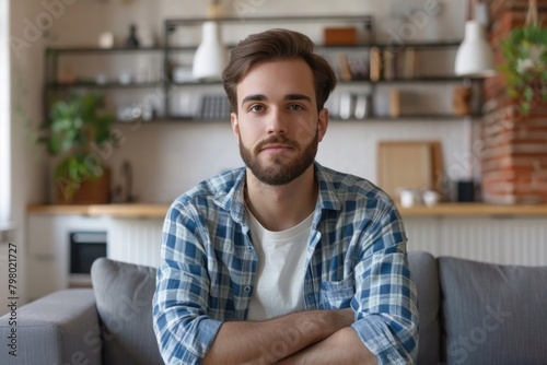 Person Looking At Camera. Millennial Guy on Sofa Making Video Call in Living Room for Distance Hiring Interview Process