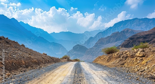 Mountains Road. Dirt Road in Hajar Mountains, Dubai, UAE - Arabian Beauty under Bright Blue Skies photo