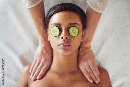 Woman, spa and neck massage for relax, masseuse hands and cucumber for dark circles. Resting, stress relief and calm for cosmetic and wellness, soothing therapy and natural or luxury treatment