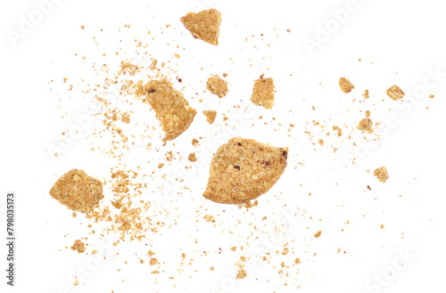 Crumbs broken wholegrain biscuit with rolled oats and fruit, isolated on white photo