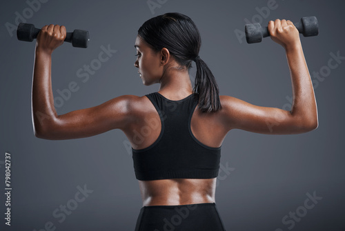 Fitness, training and woman with dumbbells, studio and gym for workout, sport and wellness in mockup. Background, sportswear and goals for body, exercise and healthy with club, athlete and girl