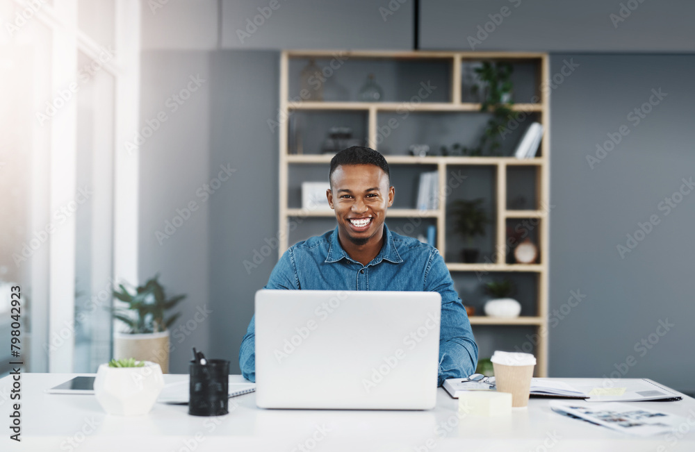 Creative, black businessman and portrait in office with laptop for interior designing with construction company for project development. Employee, happy and digital technology for research or ideas. Creative, black businessman and portrait in office with laptop for interior designing with construction company for project development. Employee, happy and digital technology for research or ideas.