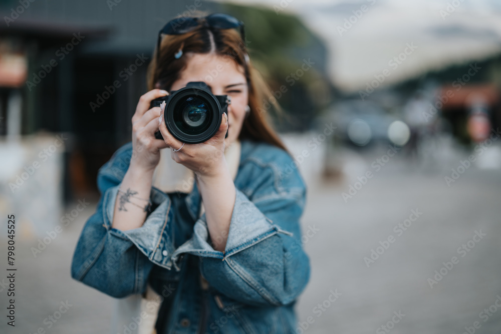 A young female photographer outdoors focuses her camera to capture enjoyable moments with friends, emitting a vibe of creativity and leisure.