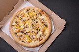Delicious pizza with corn, cheese, tomatoes and mushrooms, salt, spices and herbs
