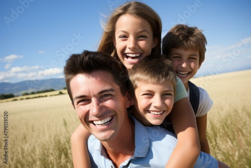 b'Happy family of four in a wheat field'