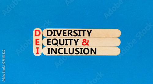 DEI diversity equity and inclusion symbol. Concept words DEI diversity equity and inclusion on stick. Beautiful blue background. Business DEI diversity equity and inclusion concept. Copy space. © Dzmitry