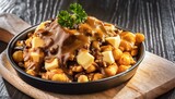 Canadian Poutine food dish with French fries and cheese curds topped with a brown gravy
