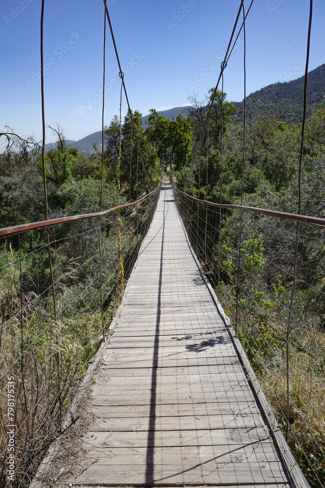 Obraz premium Pirque, Chile - 25 Nov, 2024: A suspension footbridge across a stream in the Maipo Valley, Santiago, Chile