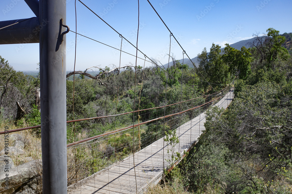 Obraz premium Pirque, Chile - 25 Nov, 2024: A suspension footbridge across a stream in the Maipo Valley, Santiago, Chile