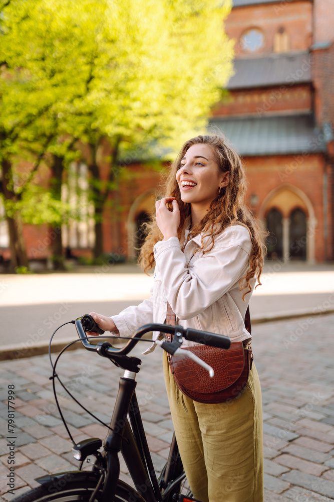Happy woman riding bicycle at the city street outdoor. Active lifestyle. The concept of nature. Happy woman riding bicycle at the city street outdoor. Active lifestyle. The concept of nature.