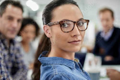Portrait, serious leader and business woman in office with team for job, coworking or about us at startup meeting. Face, confidence or professional manager, creative entrepreneur or editor in glasses
