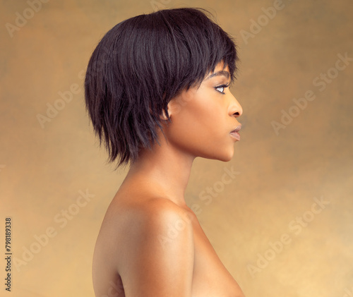 African woman, beauty and profile in studio for skincare, cosmetics and hair style on brown or yellow background. Young model thinking of smooth foundation, dermatology and aesthetic or makeup idea